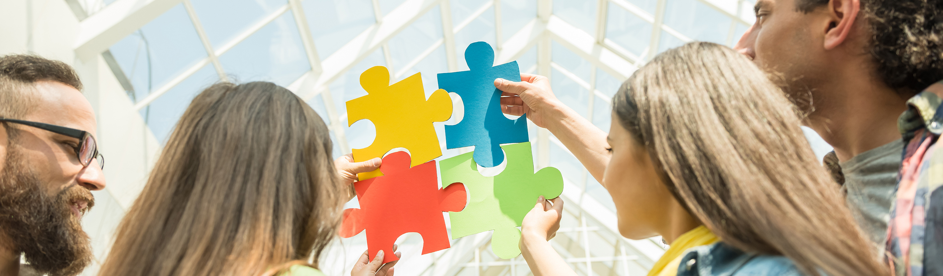Micro-credentials blog divider Holding puzzle pieces together into a connected shape